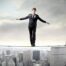 Person Walking the Wire Over City