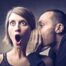 Man Whispering in Woman's Ear